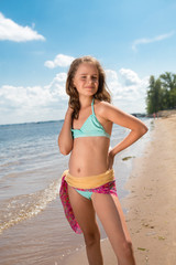 Portrait of merry little girl posing at camera