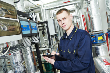 heating engineer repairman in boiler room