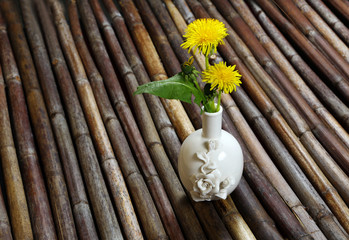 Vase with dandelions