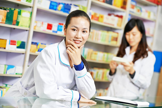 Chinese Pharmacy Worker In China Drugstore