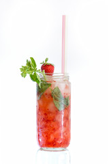 red cocktail with strawberry and straw over white background