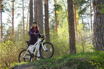 Fototapeta premium Bike riding - woman on bike in forest