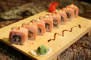 Delicious Sapporo maki sushi rolls served with a wood plate