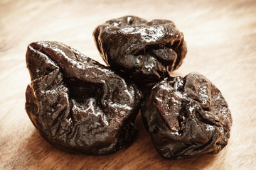 dried plums prunes on wooden table