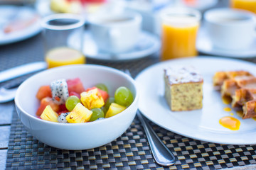 Fresh fruit salad, waffles, cake, coffee and juice served for