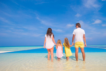 Beautiful family of four during summer tropical vacation