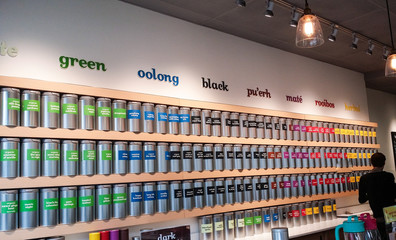 Store interior with bright tea containers on shelves