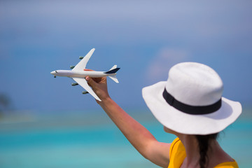 Little white toy airplane on background of turquoise sea