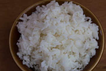 Bowl of Rice on wood background