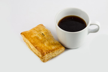 Closeup black coffee and chicken pie isolated on white backgroun