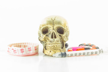 Skulls medicine and a tape measure. isolated on white