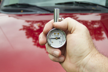 Mechanic Measuring PSI Levels In A Tire