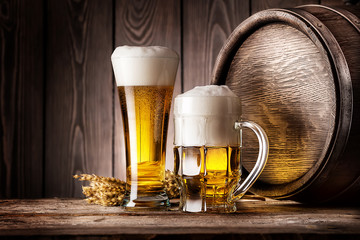 Mug and a glass of light beer with ears of barley - 83687654