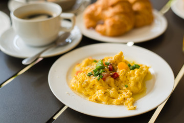 Omelets, breakfast served with coffee and croissants.