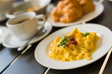Omelets, breakfast served with coffee and croissants.