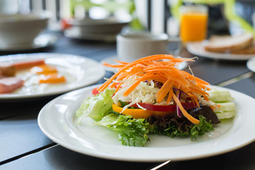 Salads vegetable breakfast served with eggs, ham, orange juice a