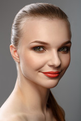Fototapeta premium Portrait of a smiling beautiful girl with bright makeup