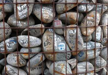 Stones with wishes and autographes in memory of vivtims of the e