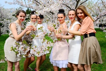 Girls with champagne celebrating in sakura's garden.