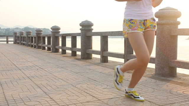 asian girl runs at sunrise