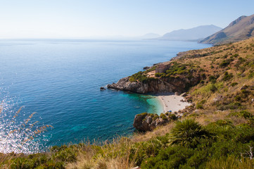 Fototapeta na wymiar Cove with white beach and pristine blue sea in sicily