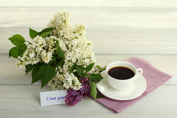 I love you note and lilac flower on the wooden table