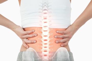 Highlighted spine of woman with back pain - obrazy, fototapety, plakaty