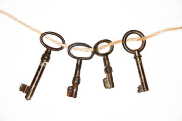 A lot vintage keys from the locks on a white background
