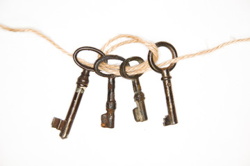 A lot vintage keys from the locks on a white background
