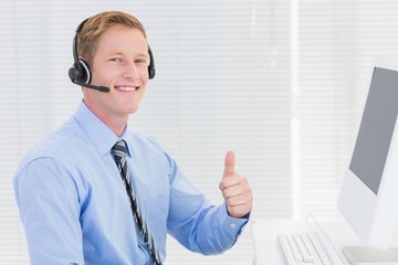 Handsome agent with headset smiling at camera