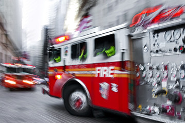 Fototapeta na wymiar fire trucks and firefighters brigade in the city