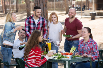 Friends taking pictures together at barbecue