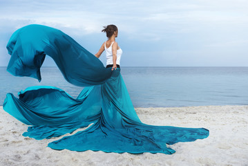 Beautiful Girl With  fabric on The Beach. 