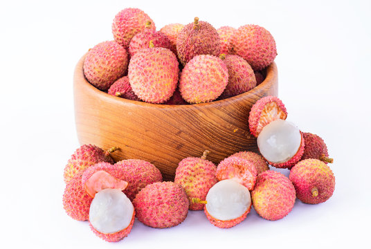 Fresh lychee in bowl on a wooden background