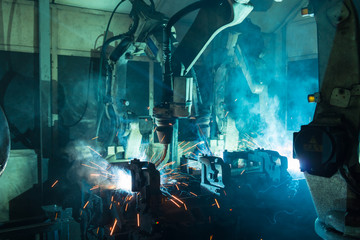 robots welding in a car factory