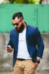 Bearded businessman looking at phone