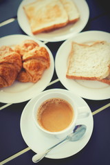 Croissant Breakfast served with black coffee and breakfast menu.