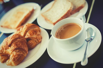 Croissant Breakfast served with black coffee and breakfast menu.