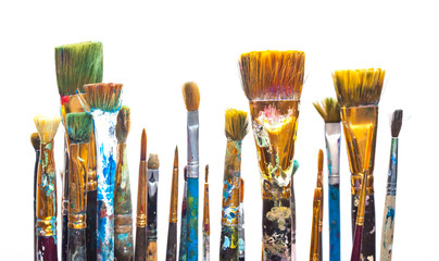 Paints and brushes on white background
