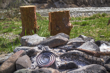 Extinct fire on the river bank