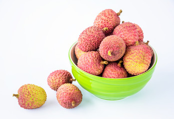 Ripe lychee fruit in green bowl against white background