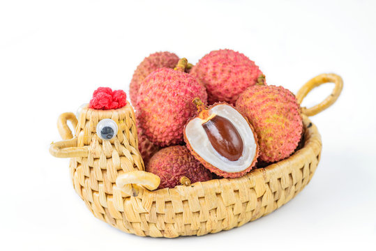 Ripe lychee fruit in hen basket against white background