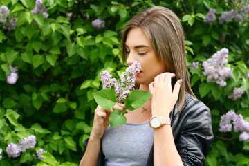 Young woman smelling flowers - obrazy, fototapety, plakaty