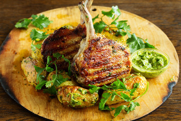 Grilled pork chop on the bone with spicy potatoes.  