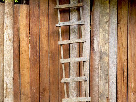 Hardwood handmade ladder with old wood wall background