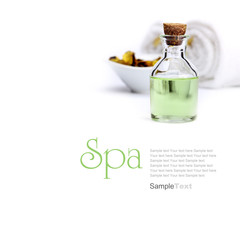 Spa concept. Green oil, yellow potpourri in vessel and towels.