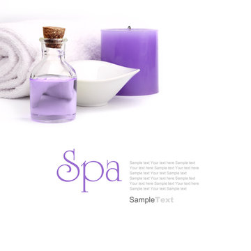 Spa concept. Purple oil, vessel candle and towel.