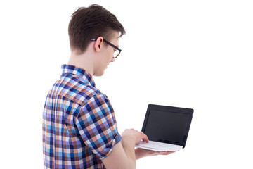 back view of handsome teenage boy holding laptop with blank scre