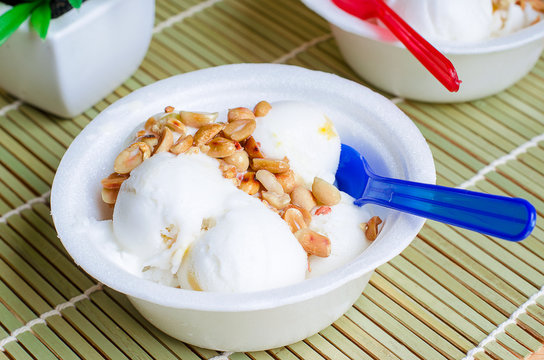 Coconut ice cream homemade with roasted peanuts