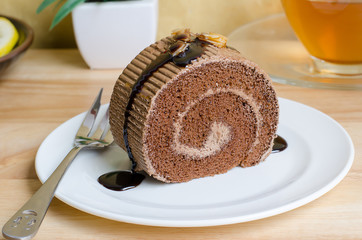 Chocolate roll cake with caramel and chocolate sauce